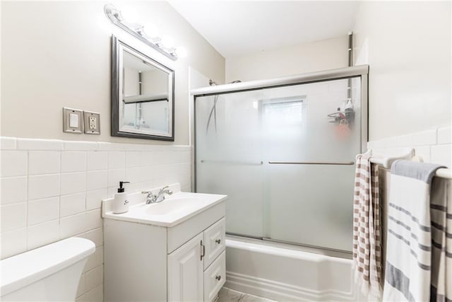 702 Green St, Lees Summit, MO 64063 - full bathroom with tile walls, vanity, enclosed tub / shower combo, and wainscoting