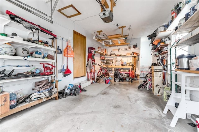 702 Green St, Lees Summit, MO 64063 - garage with a garage door opener and a workshop area