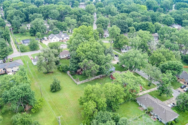 702 Green St, Lees Summit, MO 64063 - aerial overview of property's location with nearby suburban area and a tree filled landscape