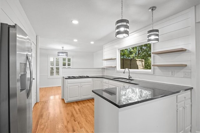 1467 E Orleans Dr, Olathe, KS 66062 - kitchen featuring stainless steel refrigerator with ice dispenser, a peninsula, open shelves, light wood finished floors, and white cabinets