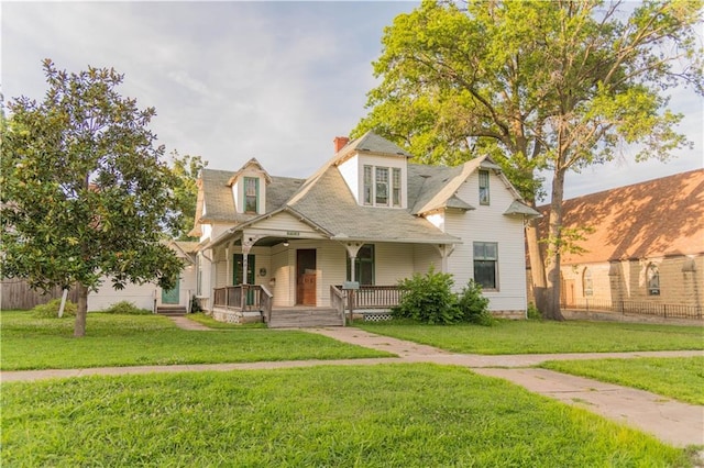 708 Osage St, Neodesha, KS 66757 - view of front of home featuring covered porch and a chimney