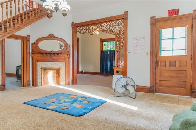 708 Osage St, Neodesha, KS 66757 - entryway featuring carpet, stairway, a fireplace, and healthy amount of natural light