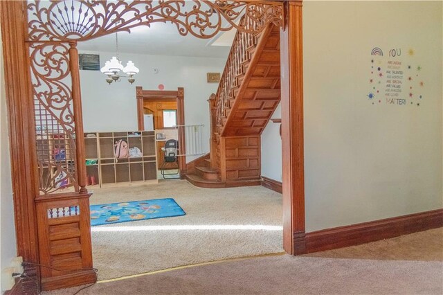 708 Osage St, Neodesha, KS 66757 - stairs with carpet flooring and a chandelier