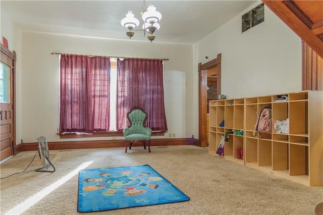 708 Osage St, Neodesha, KS 66757 - rec room featuring carpet, plenty of natural light, and a chandelier