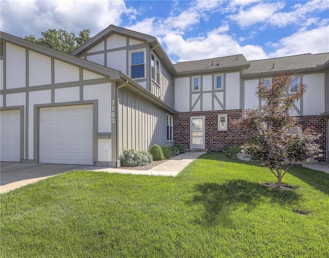 7103 Mastin St, Merriam, KS 66203 - english style home with brick siding, a front lawn, concrete driveway, an attached garage, and stucco siding
