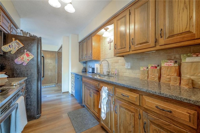 7103 Mastin St, Merriam, KS 66203 - kitchen with brown cabinetry, electric range, light wood-type flooring, dishwasher, and tasteful backsplash
