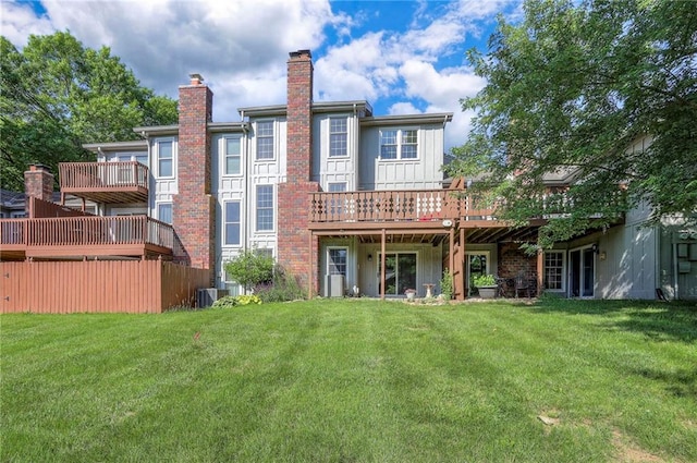 7103 Mastin St, Merriam, KS 66203 - back of house featuring a chimney, a yard, and a wooden deck