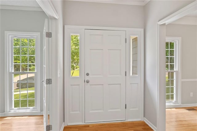 15614 Outlook St, Overland Park, KS 66223 - entryway with ornamental molding, plenty of natural light, and light wood-style flooring