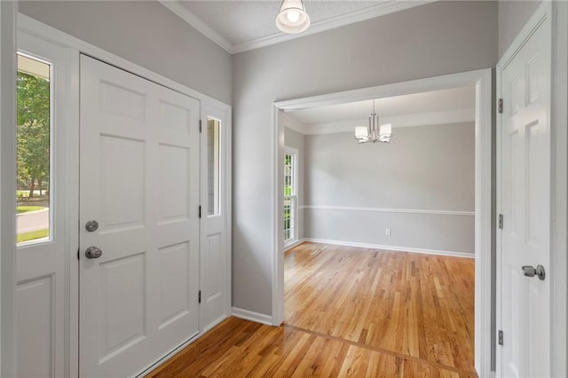 15614 Outlook St, Overland Park, KS 66223 - entryway with healthy amount of natural light, light wood-style floors, a chandelier, and ornamental molding