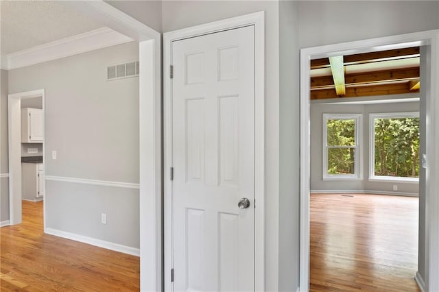 15614 Outlook St, Overland Park, KS 66223 - corridor with wood finished floors, beamed ceiling, and ornamental molding