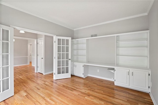 15614 Outlook St, Overland Park, KS 66223 - unfurnished office with ornamental molding, built in desk, light wood finished floors, and french doors
