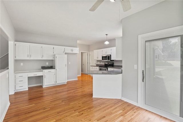 15614 Outlook St, Overland Park, KS 66223 - kitchen featuring stainless steel appliances, dark countertops, white cabinets, and light wood-style flooring