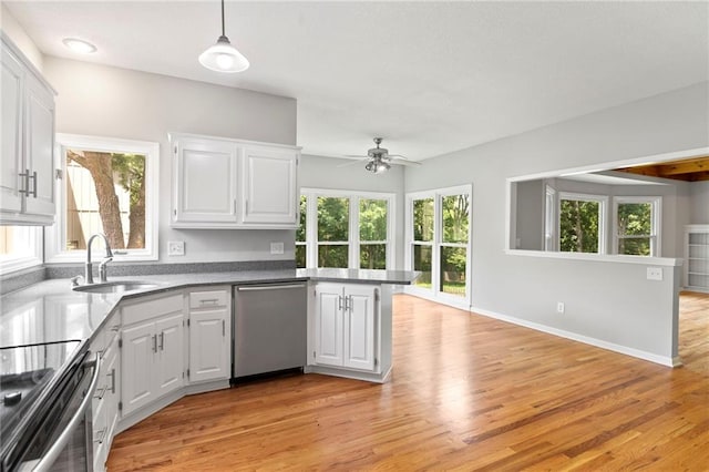 15614 Outlook St, Overland Park, KS 66223 - kitchen featuring stainless steel appliances, a peninsula, light wood-style flooring, white cabinetry, and ceiling fan
