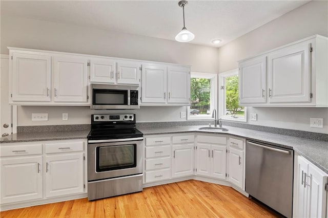 15614 Outlook St, Overland Park, KS 66223 - kitchen with stainless steel appliances, white cabinets, and light wood-style floors