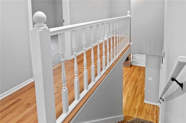 15614 Outlook St, Overland Park, KS 66223 - staircase featuring wood finished floors