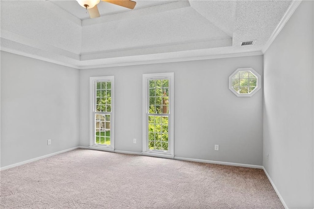 15614 Outlook St, Overland Park, KS 66223 - carpeted empty room featuring a raised ceiling, healthy amount of natural light, a textured ceiling, ornamental molding, and ceiling fan