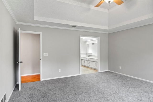 15614 Outlook St, Overland Park, KS 66223 - empty room featuring a tray ceiling, light carpet, ceiling fan, and ornamental molding