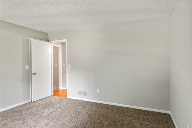 15614 Outlook St, Overland Park, KS 66223 - spare room featuring carpet and a textured ceiling