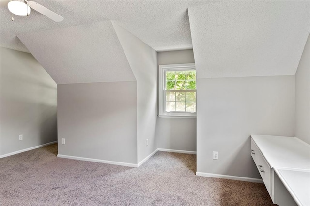 15614 Outlook St, Overland Park, KS 66223 - additional living space with a textured ceiling, lofted ceiling, carpet floors, and ceiling fan