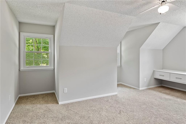 15614 Outlook St, Overland Park, KS 66223 - bonus room featuring a textured ceiling, lofted ceiling, carpet flooring, and a ceiling fan