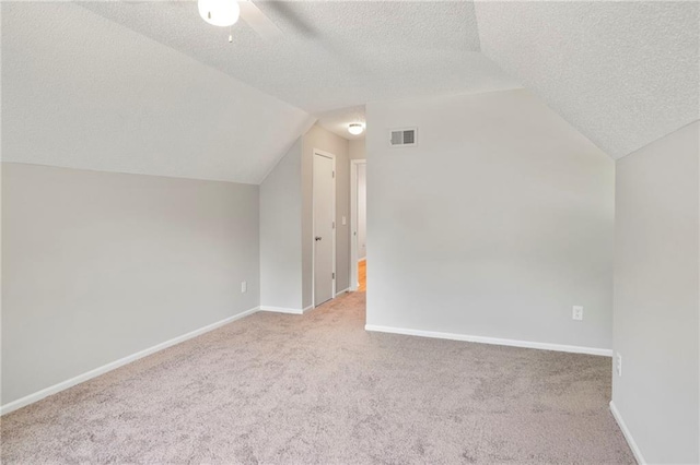 15614 Outlook St, Overland Park, KS 66223 - additional living space with a textured ceiling, vaulted ceiling, carpet floors, and ceiling fan