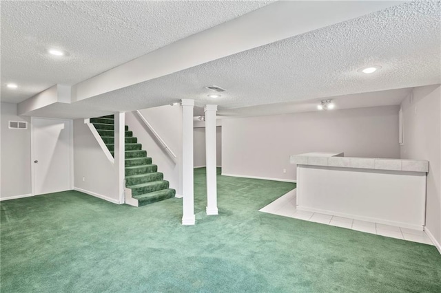 15614 Outlook St, Overland Park, KS 66223 - finished below grade area with carpet floors, a textured ceiling, stairs, a bar, and recessed lighting