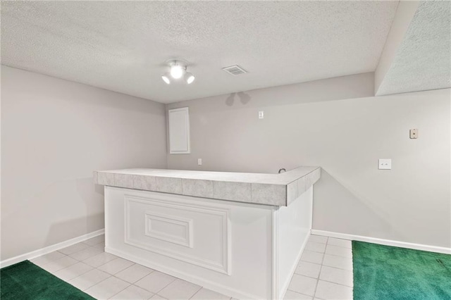 15614 Outlook St, Overland Park, KS 66223 - bar featuring light tile patterned flooring and a textured ceiling