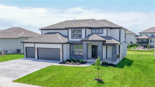 6126 Lewis Dr, Shawnee, KS 66226 - view of front of home with a garage, driveway, a shingled roof, a front yard, and stone siding