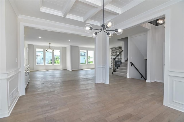 6126 Lewis Dr, Shawnee, KS 66226 - spare room featuring a chandelier, beam ceiling, coffered ceiling, light wood finished floors, and stairway
