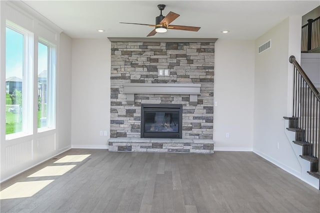 6126 Lewis Dr, Shawnee, KS 66226 - unfurnished living room featuring wood finished floors, ceiling fan, stairs, a fireplace, and recessed lighting