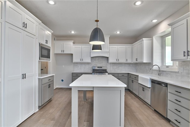 6126 Lewis Dr, Shawnee, KS 66226 - kitchen featuring appliances with stainless steel finishes, gray cabinetry, backsplash, light wood-style floors, and recessed lighting