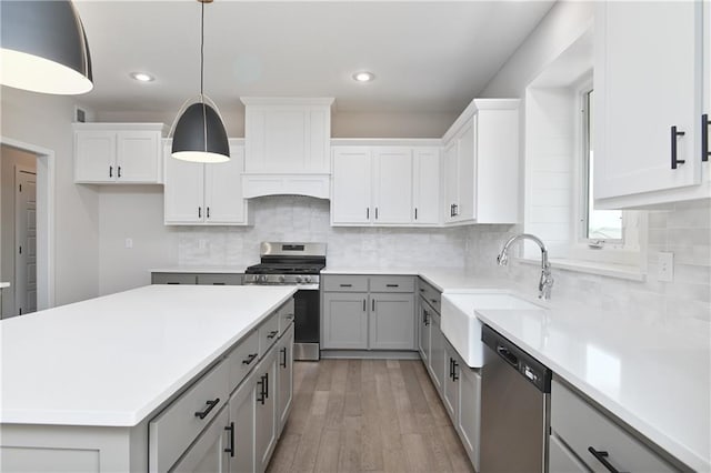 6126 Lewis Dr, Shawnee, KS 66226 - kitchen featuring appliances with stainless steel finishes, gray cabinetry, light wood finished floors, light countertops, and recessed lighting