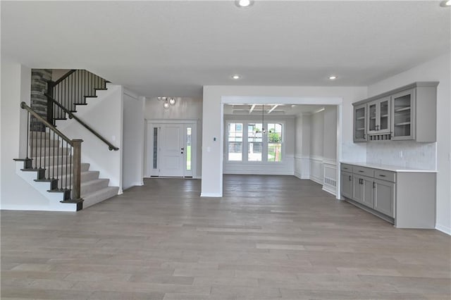 6126 Lewis Dr, Shawnee, KS 66226 - entrance foyer with stairs, light wood finished floors, recessed lighting, and wainscoting