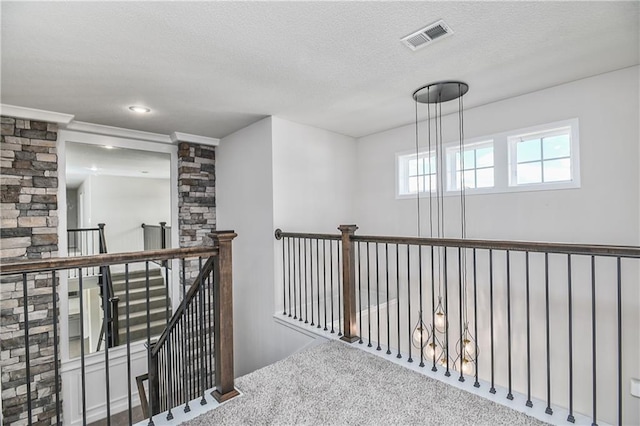 6126 Lewis Dr, Shawnee, KS 66226 - hallway with a textured ceiling, carpet, and an upstairs landing