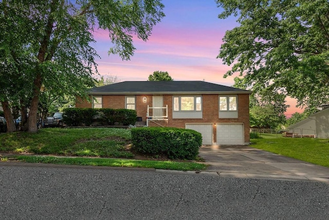 14224 E 36th St, Independence, MO 64055 - ranch-style home with concrete driveway, an attached garage, and brick siding