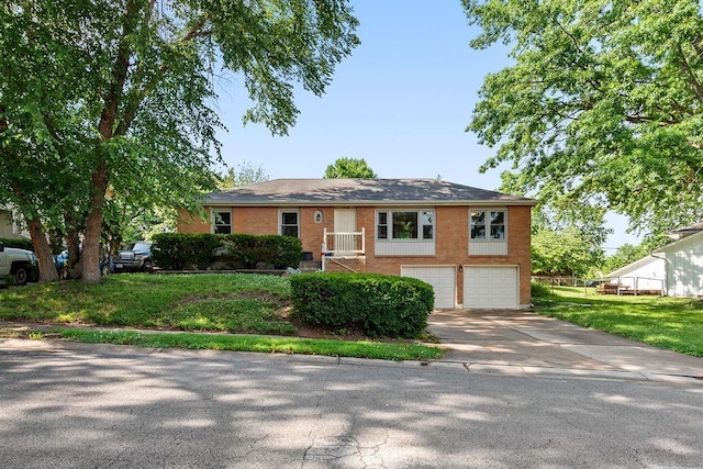 14224 E 36th St, Independence, MO 64055 - ranch-style house featuring driveway, a garage, a front lawn, and brick siding