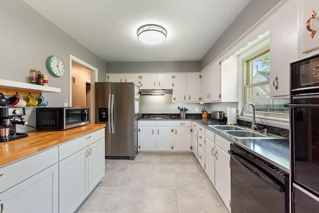 14224 E 36th St, Independence, MO 64055 - kitchen with black appliances, under cabinet range hood, white cabinets, butcher block counters, and light tile patterned flooring