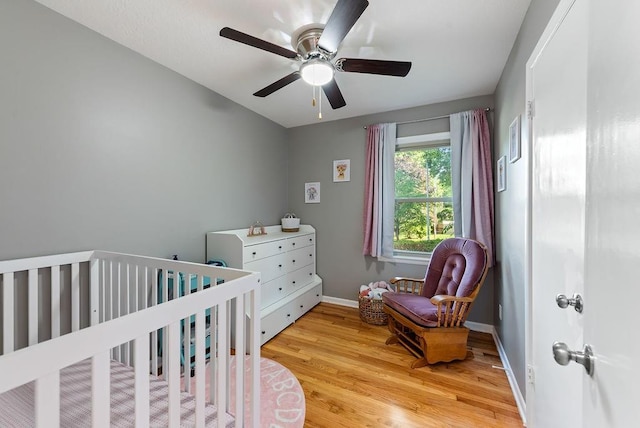 14224 E 36th St, Independence, MO 64055 - bedroom with light wood-style flooring, a crib, and ceiling fan