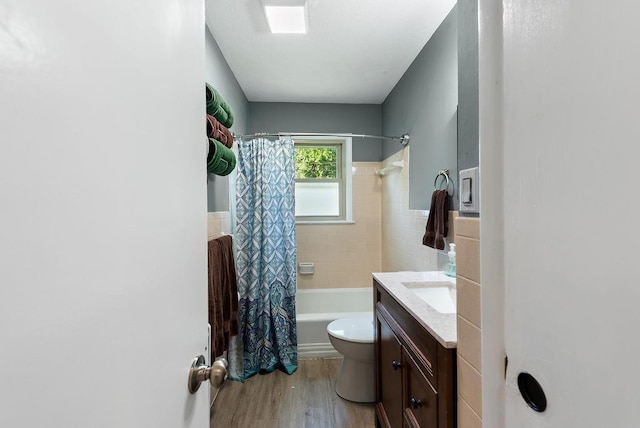 14224 E 36th St, Independence, MO 64055 - full bathroom featuring shower / bathtub combination with curtain, tile walls, vanity, wood finished floors, and a wainscoted wall