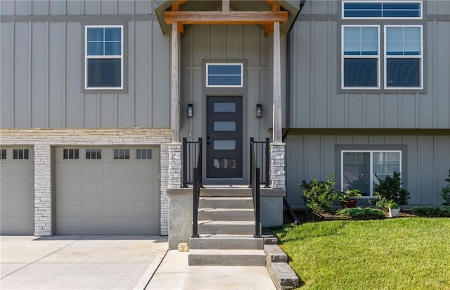 462 SE 90th Rd, Warrensburg, MO 64093 - doorway to property with board and batten siding, driveway, a lawn, and an attached garage