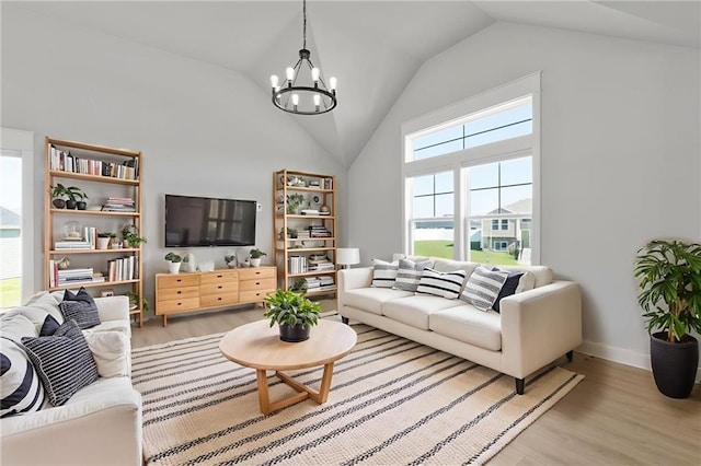 462 SE 90th Rd, Warrensburg, MO 64093 - living room featuring a chandelier, high vaulted ceiling, and light wood finished floors