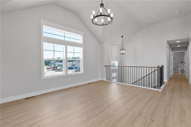 462 SE 90th Rd, Warrensburg, MO 64093 - spare room featuring a chandelier, light wood finished floors, and high vaulted ceiling