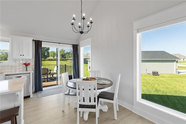 462 SE 90th Rd, Warrensburg, MO 64093 - dining space with a chandelier, light wood finished floors, and high vaulted ceiling