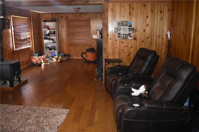 21570 Mclouth Rd, Mc Louth, KS 66054 - living room featuring wooden walls, a wood stove, and wood finished floors