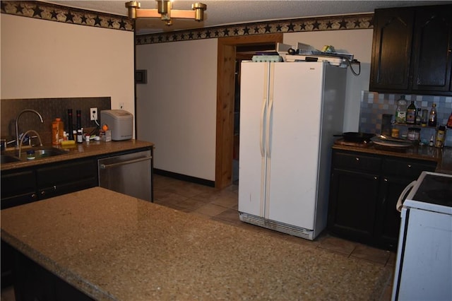 21570 Mclouth Rd, Mc Louth, KS 66054 - kitchen featuring freestanding refrigerator, stove, stainless steel dishwasher, tasteful backsplash, and light tile patterned floors