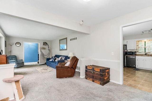 6305 N Bales Ave, Gladstone, MO 64119 - living room with light colored carpet, beam ceiling, and light tile patterned floors