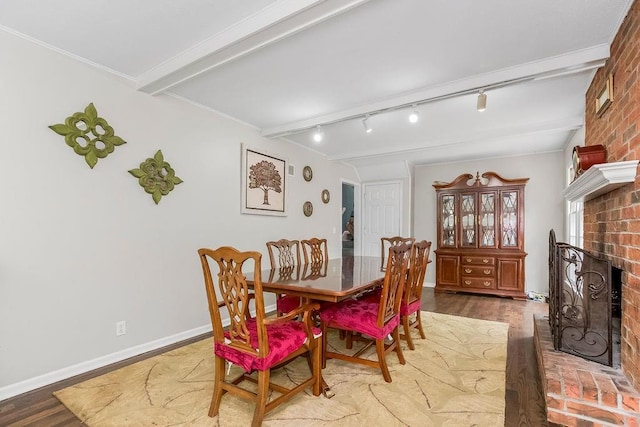 6305 N Bales Ave, Gladstone, MO 64119 - dining room with a fireplace, wood finished floors, and beamed ceiling