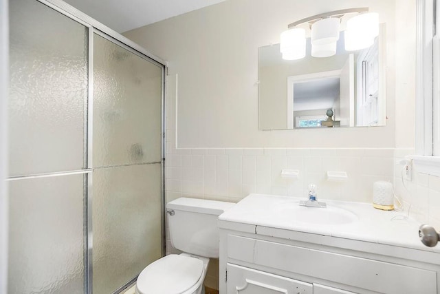 6305 N Bales Ave, Gladstone, MO 64119 - full bath featuring vanity, a stall shower, tile walls, and a wainscoted wall