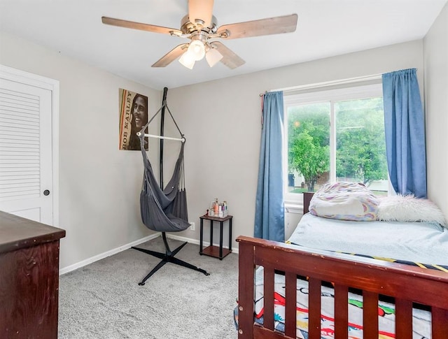 6305 N Bales Ave, Gladstone, MO 64119 - carpeted bedroom with a ceiling fan and baseboards