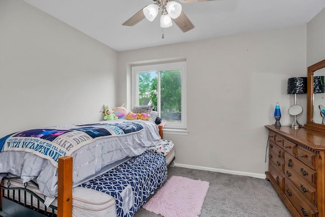 6305 N Bales Ave, Gladstone, MO 64119 - carpeted bedroom with baseboards and a ceiling fan